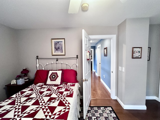 bedroom featuring dark wood finished floors and baseboards