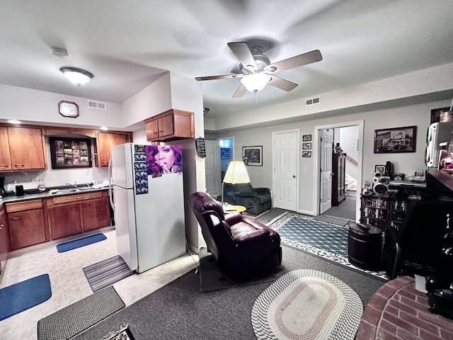 living room featuring a ceiling fan and visible vents