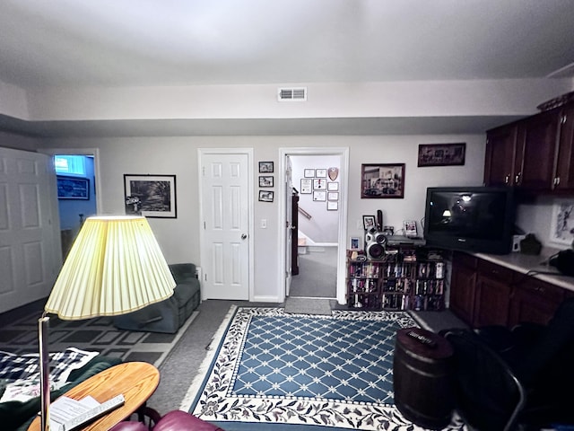 carpeted living room featuring visible vents