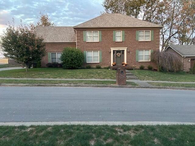 colonial-style house with a front lawn