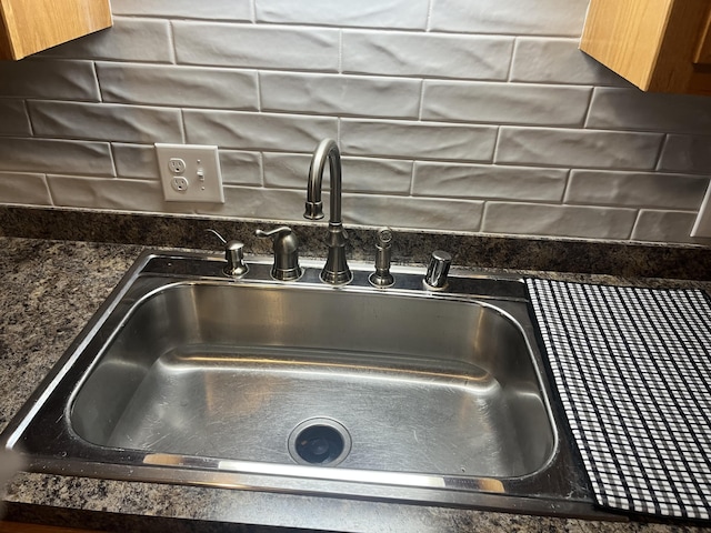 details featuring decorative backsplash and a sink