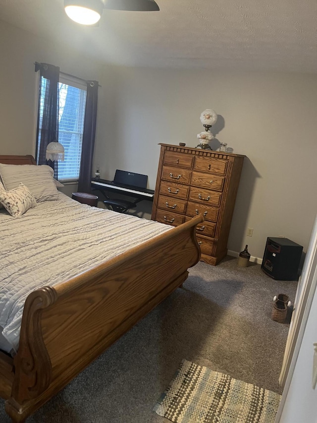 carpeted bedroom featuring baseboards and a ceiling fan