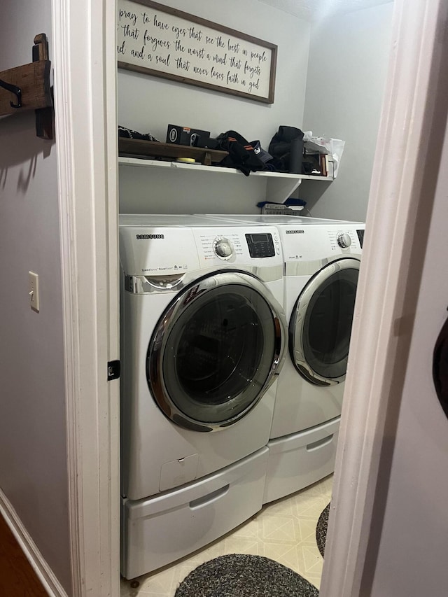 laundry room with washing machine and clothes dryer, laundry area, and light floors