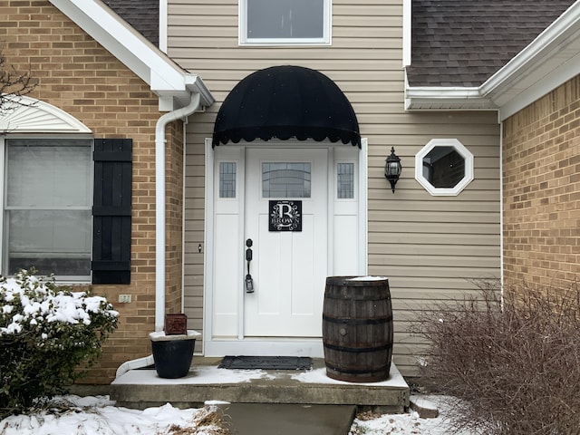 view of snow covered property entrance