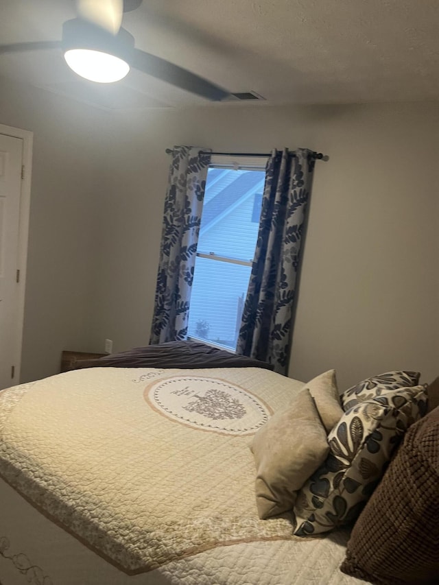 bedroom with wood finished floors and ceiling fan