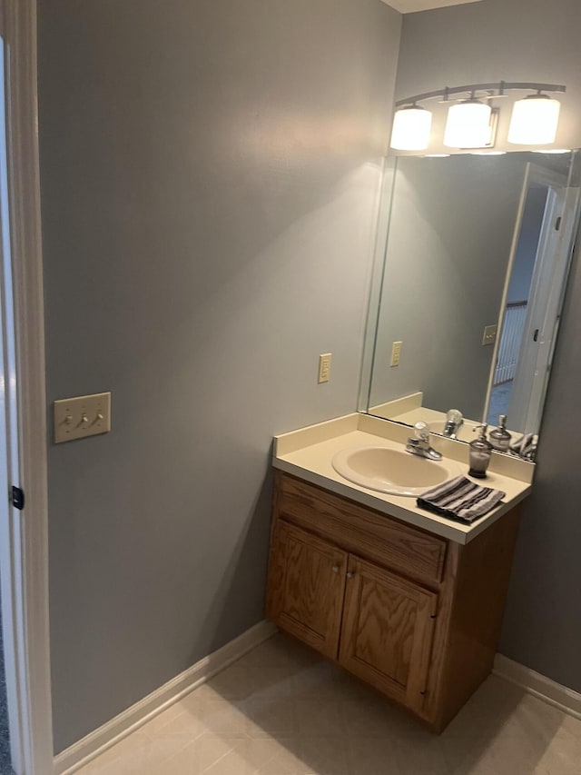 bathroom with tile patterned floors, vanity, and baseboards