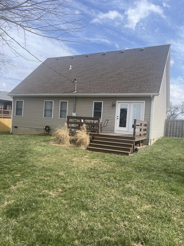 rear view of property featuring fence, a yard, a wooden deck, a shingled roof, and crawl space