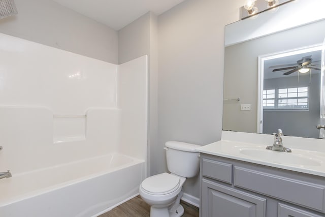 full bathroom featuring hardwood / wood-style flooring, ceiling fan, vanity, shower / bathing tub combination, and toilet