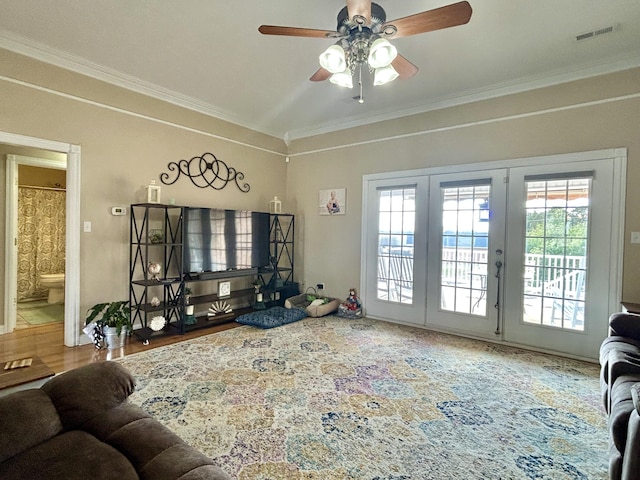 living room with crown molding, ceiling fan, and a wealth of natural light