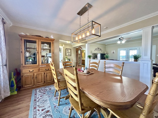 dining area featuring ornate columns, crown molding, ceiling fan, and light hardwood / wood-style floors