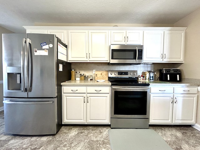 kitchen with white cabinetry, decorative backsplash, stainless steel appliances, and a textured ceiling