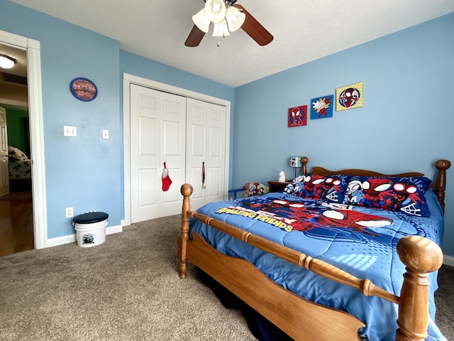 carpeted bedroom featuring ceiling fan and a closet