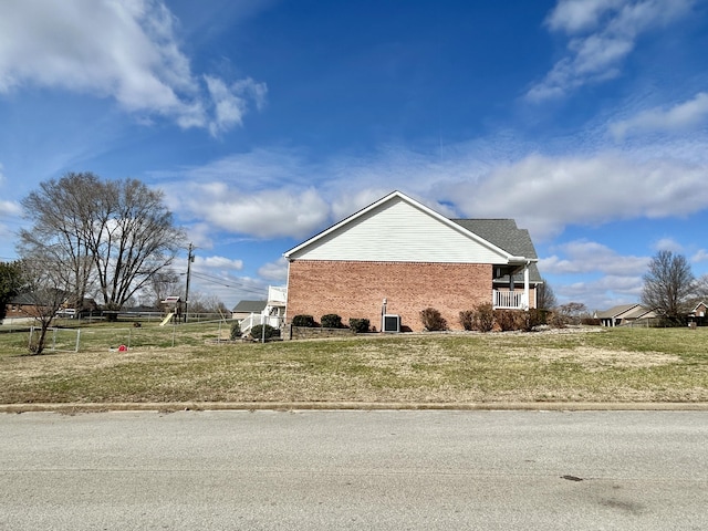 view of side of property with a yard