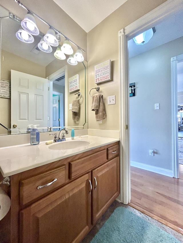 bathroom with vanity and hardwood / wood-style floors