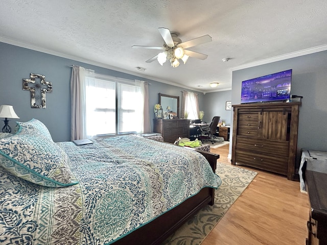 bedroom with ceiling fan, ornamental molding, hardwood / wood-style floors, and a textured ceiling