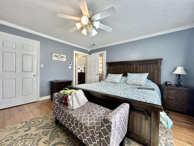 bedroom with crown molding, ceiling fan, and light wood-type flooring