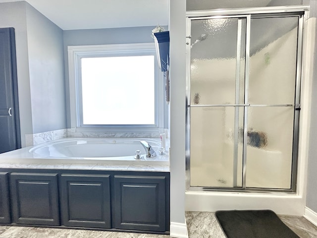 bathroom featuring separate shower and tub