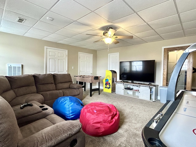 carpeted living room with a paneled ceiling and ceiling fan