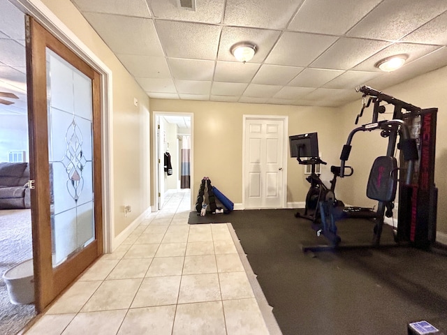 workout area with light tile patterned floors and a drop ceiling