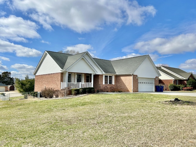 view of front of home with fence, covered porch, brick siding, and a garage