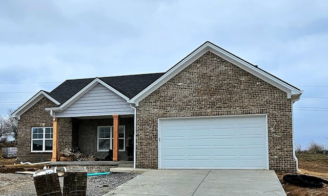 view of front of home featuring a garage, brick siding, and driveway