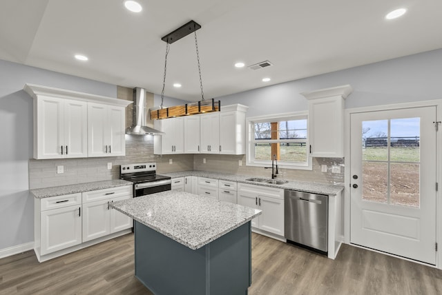 204 Max Cavnes Rd, Danville, KY 40422 - kitchen with visible vents, wall chimney range hood, wood finished floors, stainless steel appliances, and a sink