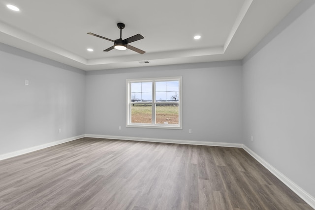 204 Max Cavnes Rd, Danville, KY 40422 - spare room featuring dark wood-type flooring, a raised ceiling, and baseboards