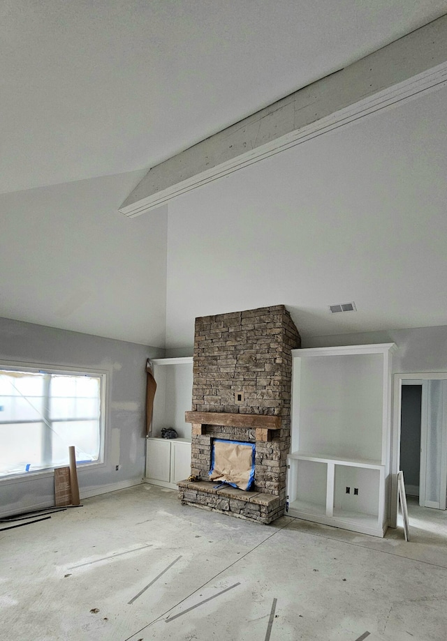 unfurnished living room featuring high vaulted ceiling, beamed ceiling, and a stone fireplace