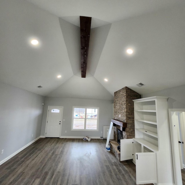 unfurnished living room featuring lofted ceiling with beams, a fireplace, visible vents, baseboards, and dark wood-style floors