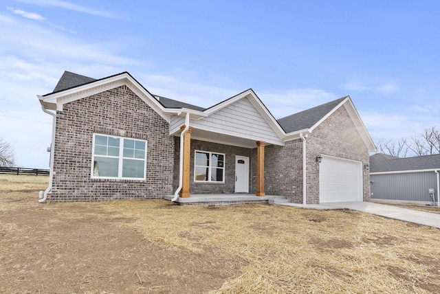 204 Max Cavnes Rd, Danville, KY 40422 - view of front facade featuring brick siding, fence, a porch, a garage, and driveway