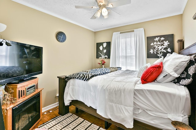 bedroom with dark wood-style floors, crown molding, ceiling fan, and a textured ceiling