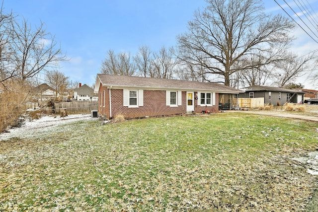 single story home with a front yard, fence, central AC, and brick siding