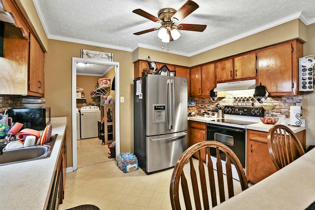 kitchen featuring washer / dryer, electric range oven, stainless steel fridge with ice dispenser, light countertops, and under cabinet range hood