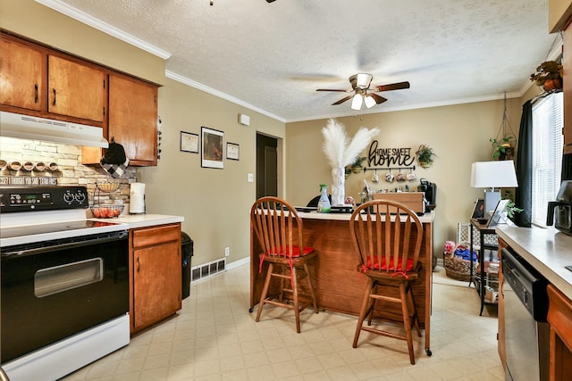 kitchen with electric stove, light floors, light countertops, under cabinet range hood, and stainless steel dishwasher