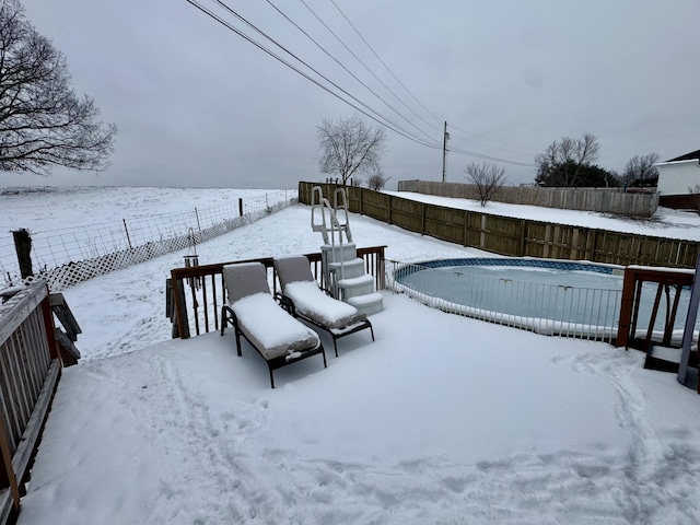 yard covered in snow featuring fence