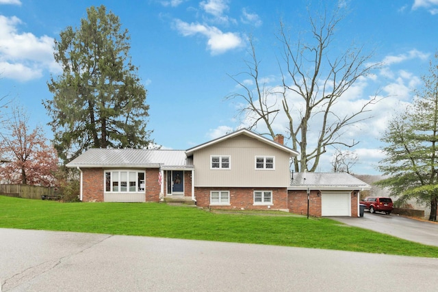 tri-level home with a garage and a front lawn