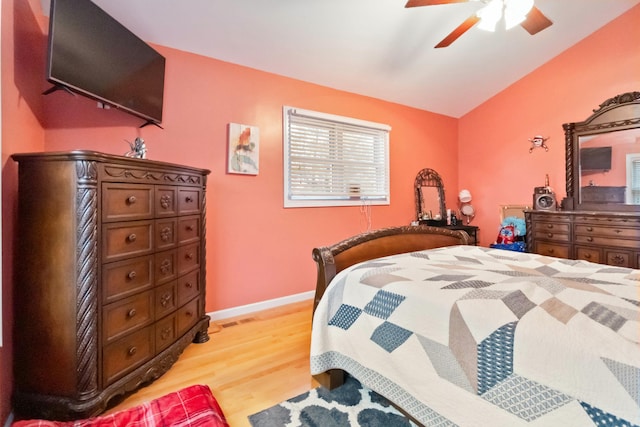 bedroom with vaulted ceiling, ceiling fan, and light wood-type flooring