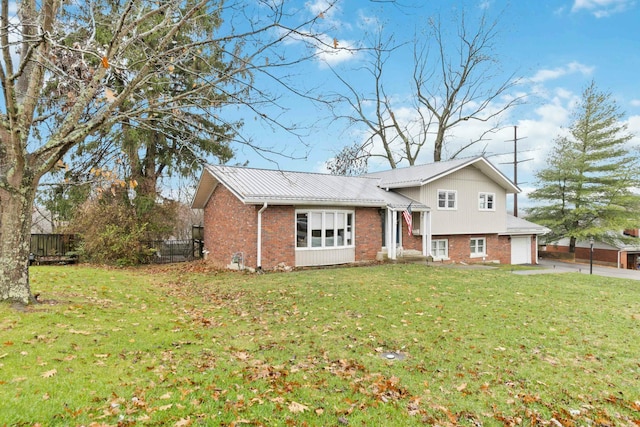 view of front of property featuring a garage and a front lawn