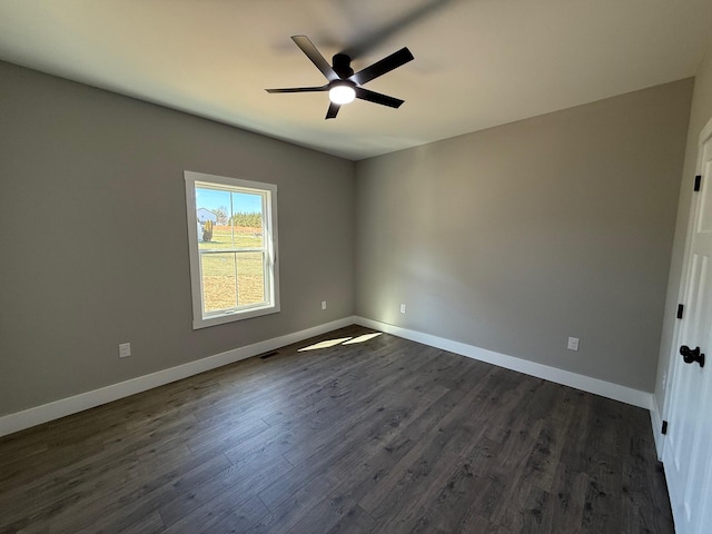 empty room with dark wood-type flooring and ceiling fan