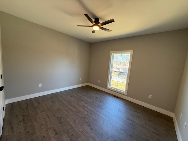 spare room with ceiling fan and dark hardwood / wood-style flooring