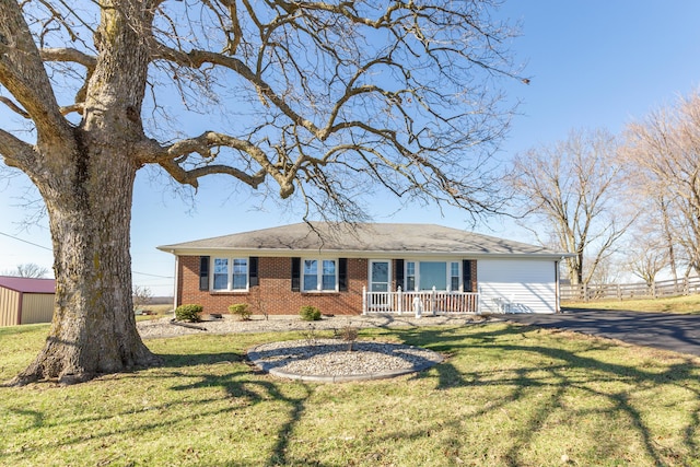 single story home with crawl space, covered porch, a front yard, and brick siding