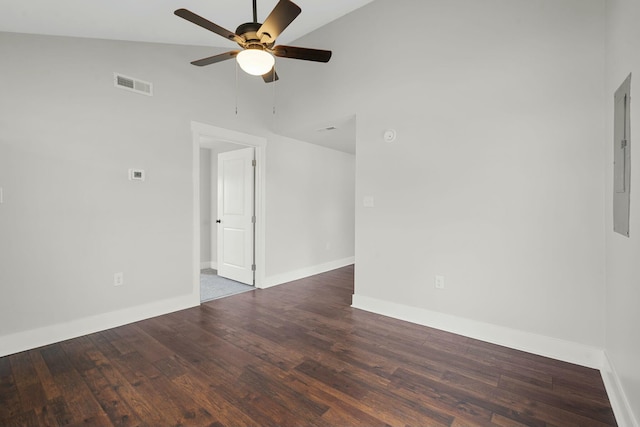 spare room with lofted ceiling, visible vents, ceiling fan, wood finished floors, and baseboards