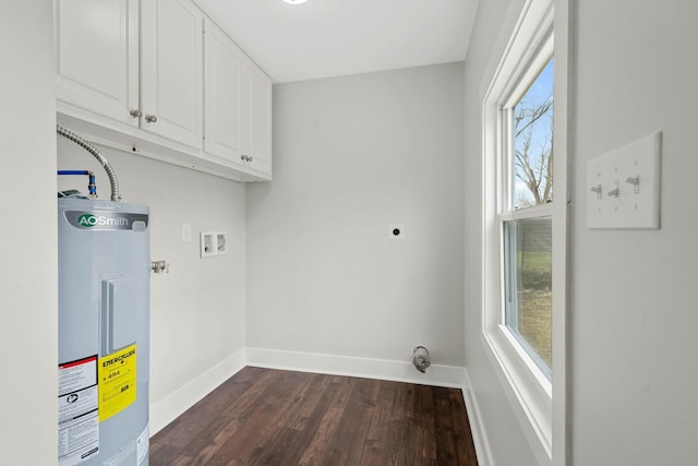 washroom featuring cabinet space, baseboards, dark wood-style floors, hookup for an electric dryer, and water heater