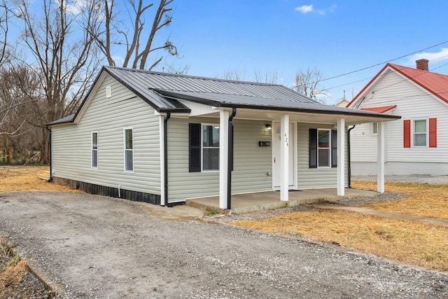 view of front of house featuring covered porch and metal roof