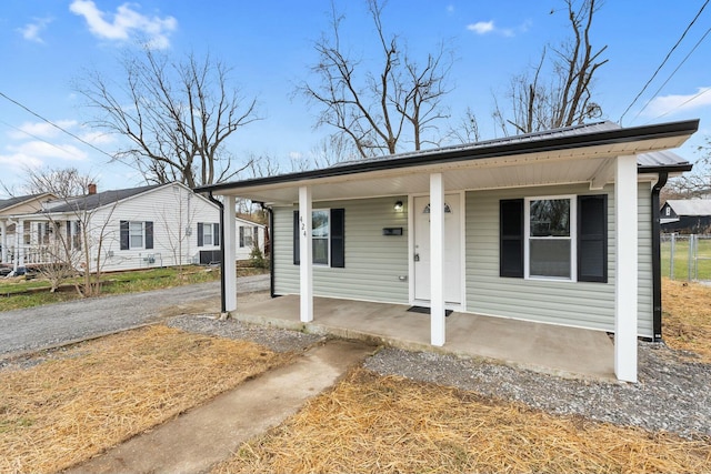 bungalow-style home featuring covered porch and central air condition unit