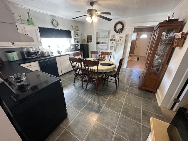 dining room featuring dark tile patterned floors and ceiling fan