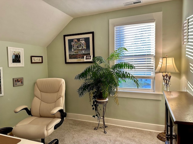 living area with vaulted ceiling, light carpet, visible vents, and baseboards