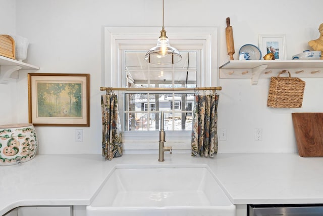 room details featuring dishwasher, open shelves, and light countertops