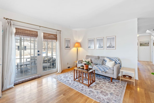 living area featuring french doors and wood finished floors