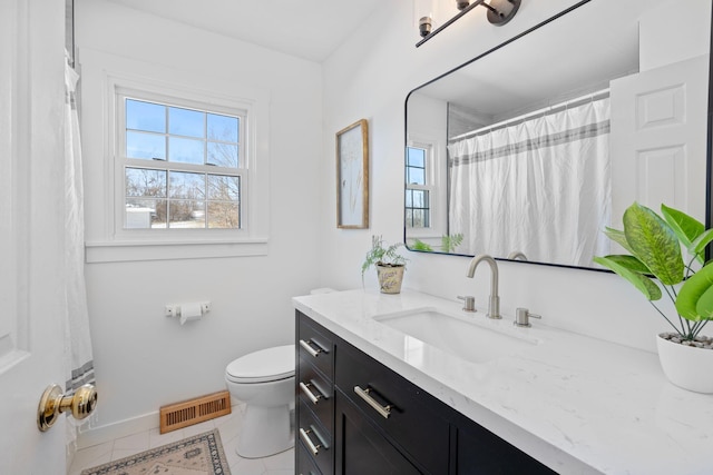 full bathroom with visible vents, toilet, vanity, baseboards, and tile patterned floors